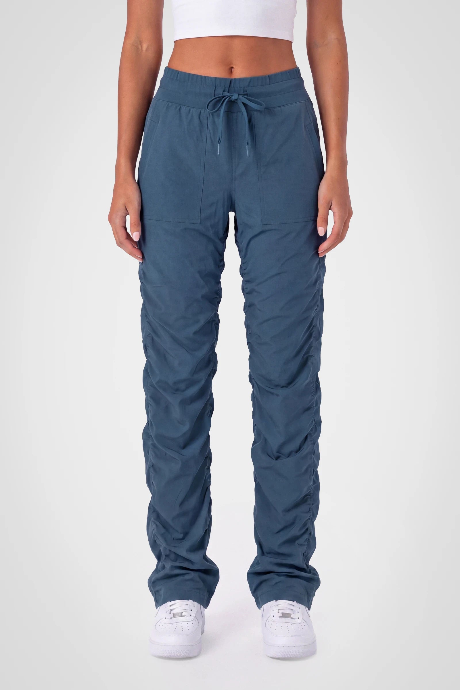 Women’s Key Largo Adventurous Pant, front studio view showing the elastic drawstring waist, utility patch pockets and gathered cuffs.