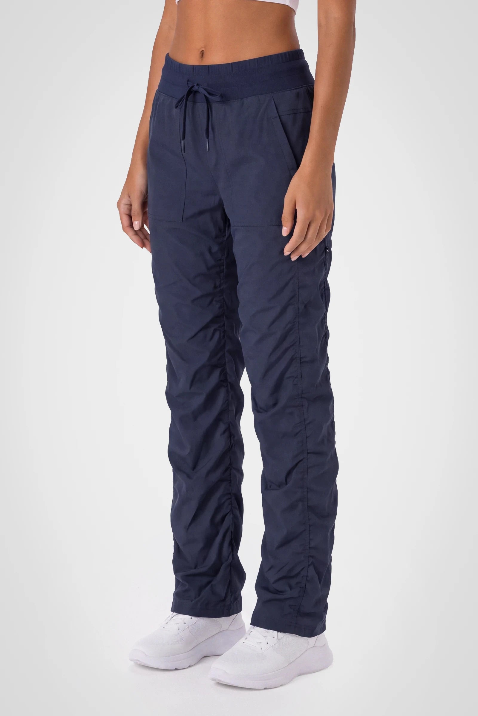 Women’s Navy Adventurous Pant, rear studio view showing the relaxed fit through the seat and ankle.